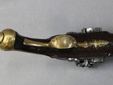a close up of a brass plated musical instrument on a white surface