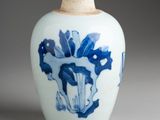 a blue and white vase with a horse on it