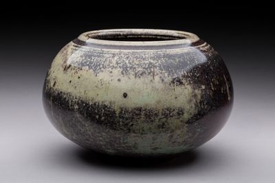 a black and white vase sitting on a table