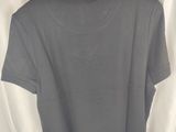 a grey shirt hanging on a wooden hanger on a white curtain