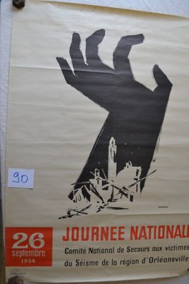 a poster on the wall of a building with a zombie hand coming out of it
