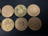 six different types of coins are shown on a black surface
