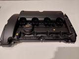 a close up of a black engine cover on a white table