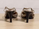 pair of women ' s high heeled shoes on a wooden table