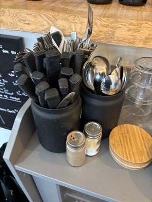 many utensils and spoons sitting on a counter