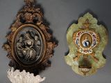two wall plaques with a picture of a woman and a man in a gold frame