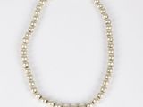 a white pearl necklace on a white background