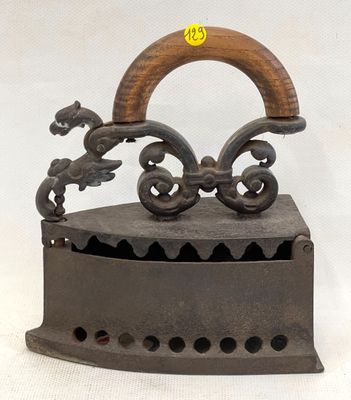 an old iron with a wooden handle on a white background