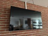 a flat screen tv mounted on a brick wall
