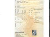 une image d'un document sur lequel figure la photo d'un homme