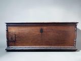 an old wooden chest sitting on top of a white surface