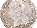 gros plan d'une pièce de monnaie sur laquelle figure une tête de femme