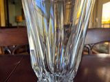 a glass vase sitting on a table in a room