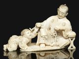 chinese carved ivory figurine of a man and child on a bench