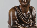 an image of a bronze statue of a woman with her arms crossed