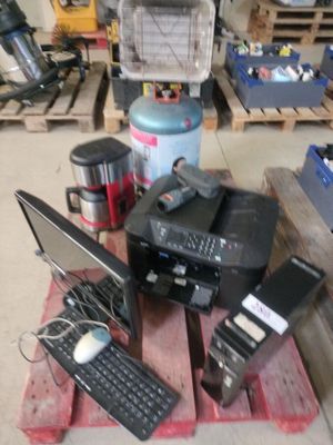 a pile of electronics on a pallet in a garage