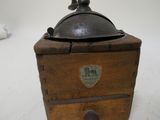 a small wooden box with a metal lid on a table