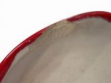 a close up of a red and white bowl on a table
