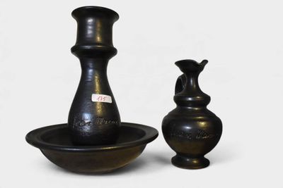 two black vases sitting next to each other on a table