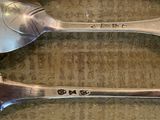 two spoons that are sitting on a table