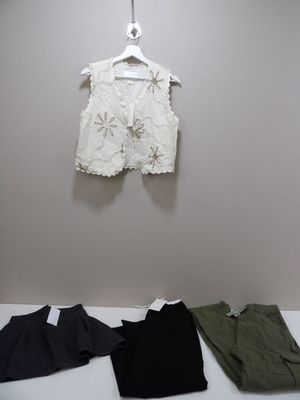 a white shirt hanging on a wall next to a pair of green pants