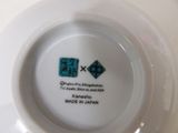 a white plate with a blue and black design on it