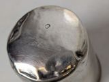 a silver salt and pepper shaker sitting on a table