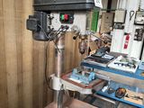 an image of a drill press in a workshop