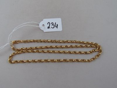 a close up of a gold chain with a price tag on it