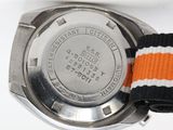 a close up of a wrist watch with an orange and white band