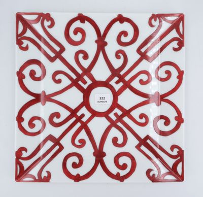 red and white plate with a decorative design on it
