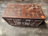 a wooden chest with a door on top of it