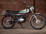 a motorcycle that is parked in front of a brick wall