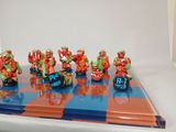 a chess board with a bunch of figurines on it