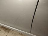 a close up of a car door with scratches on it
