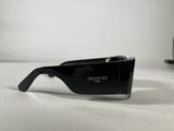 sunglasses on a table with a cup of coffee in the background