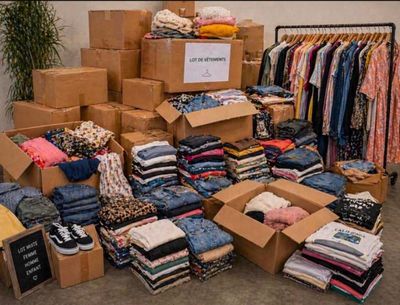 a large pile of clothes and boxes in a room