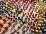 many spools of thread on a white table