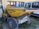 a yellow dump truck parked in front of a building
