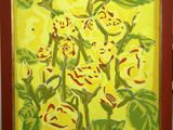 painting of yellow flowers in a red frame on a table