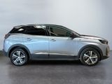 the silver car is parked in a large room with a white wall