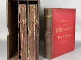 two books in a wooden box sitting next to each other on a table