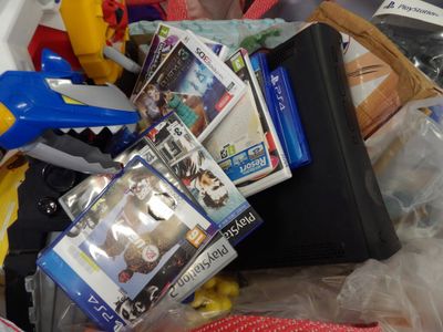 a pile of video games and other items in a bin