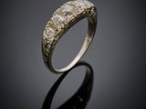 a close up of a gold and diamond ring on a black surface