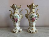 two vases that are sitting on a table