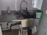 a kitchen with a sink and a counter with a faucet in it