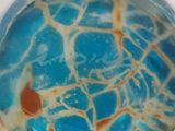 a close up of a glass object on a white surface