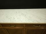 a marble counter top on a wooden cabinet