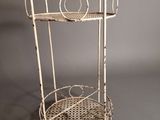 an image of a white metal shelf with a basket on top