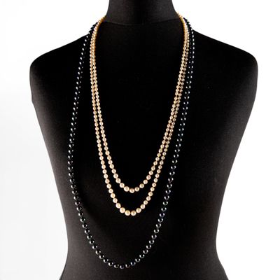 black and gold beaded necklace on a mannequin torso